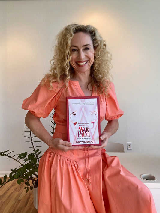 Susan Campbell holding the book “War Paint” by Lindy Woodhead